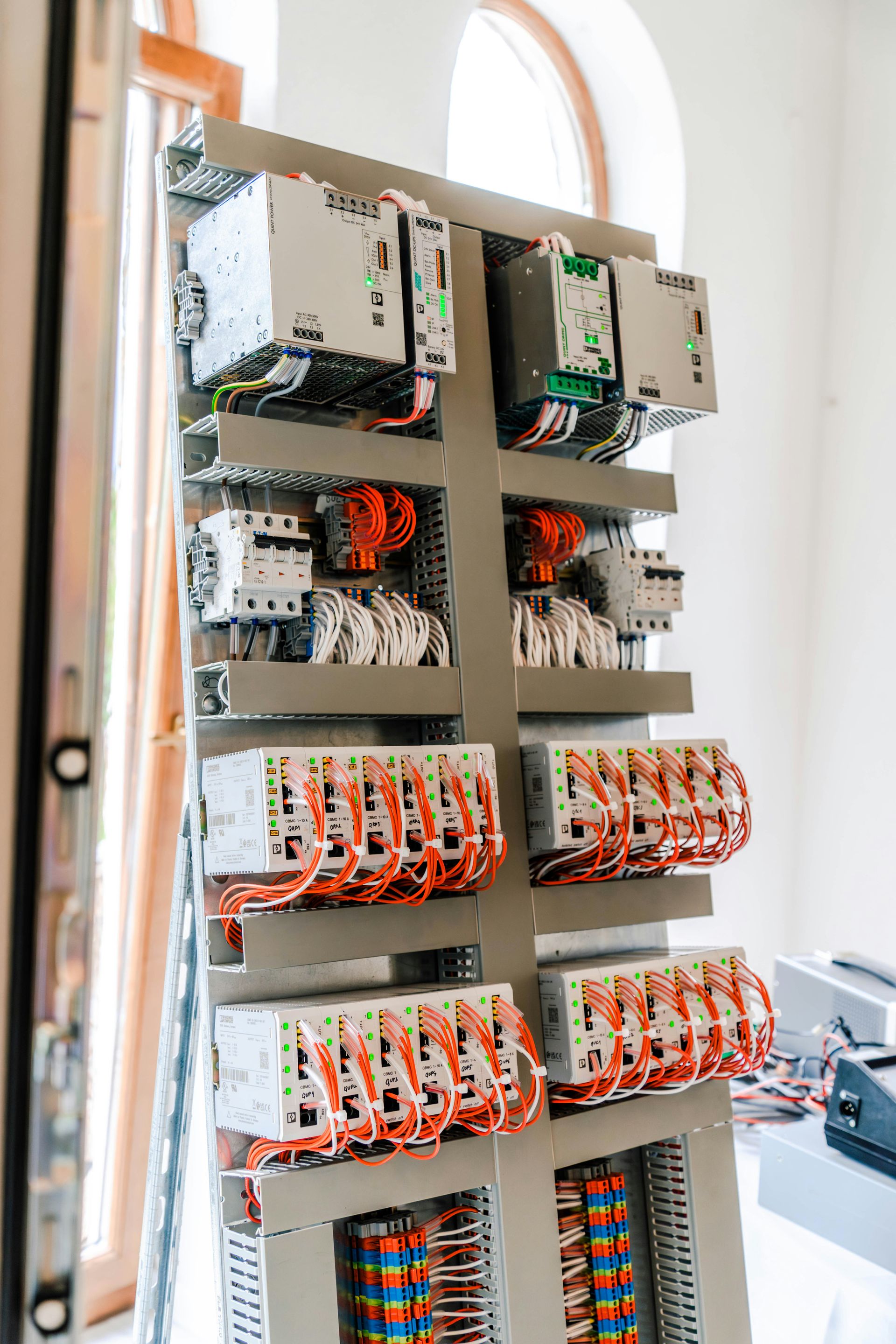An open electrical control panel with numerous wires and components.